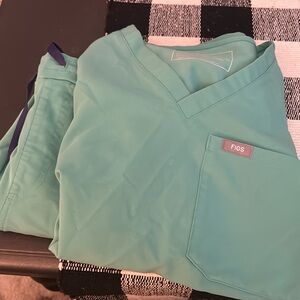 Surgical green figs scrubs. Straight leg bottoms. Both top and pants are xxs.